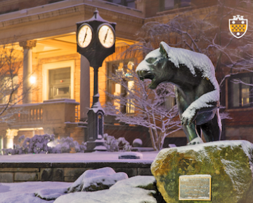 building and panther statue